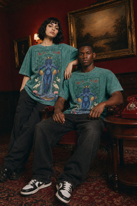 The Nile pink/red washed heavy cotton tee — male model with female model in Cairo evening room